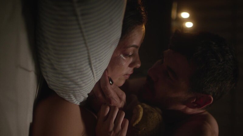Movie Scene from HILMV woman lying on bed with man holding her face