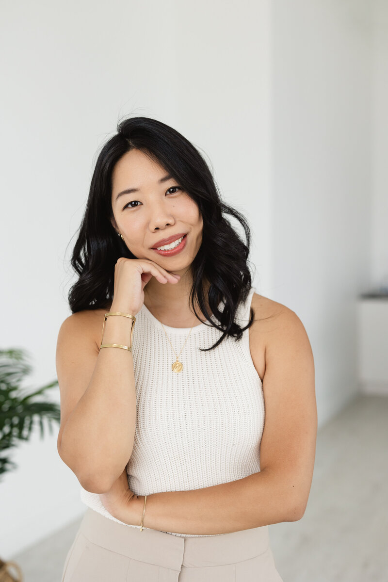 A professional solo portrait of a career woman in a studio.