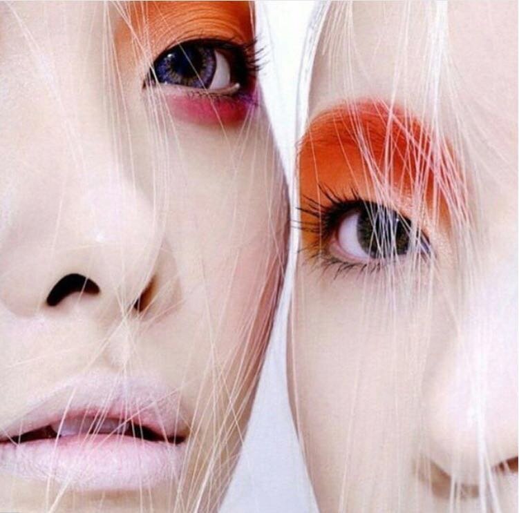 Two women close together in orange and pink eyeshadow