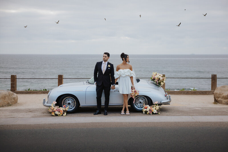 A couple celebrating their romantic beach elopement in Los Angeles, exchanging vows with the ocean as a stunning backdrop, capturing the beauty of their special day.