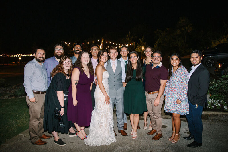 Allison Bolin Texas wedding photographer in group photo with bride and groom at wedding reception