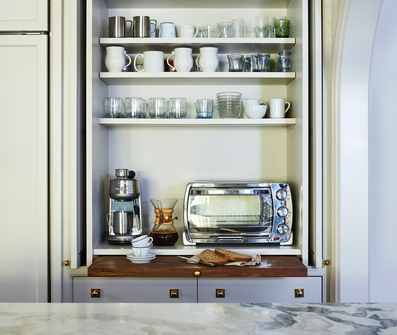 Kitchen designer in Boston custom cabinets classic home includes a light grey coffee station in a hidden pantry with built-in storage and custom millwork.