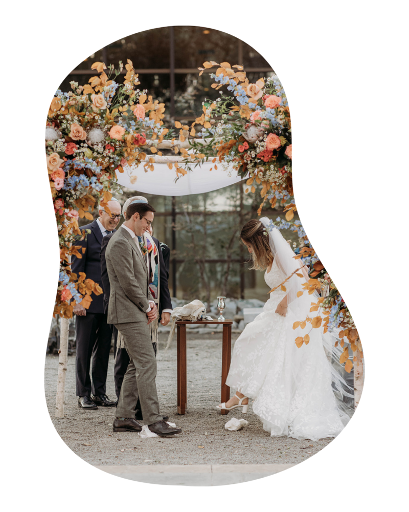 Lush ceremony floral arch in pink, orange, and coral tones, created for a modern wedding in Fort Worth. Designed by The Floral Eclectic.