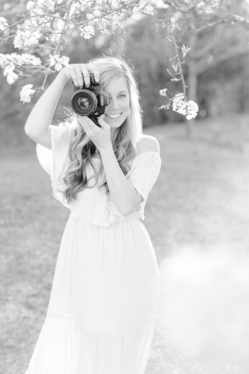 Jess Becker smiling and holding her camera