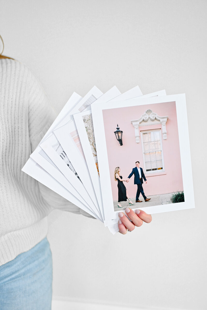 charleston family photographer holding matted prints\