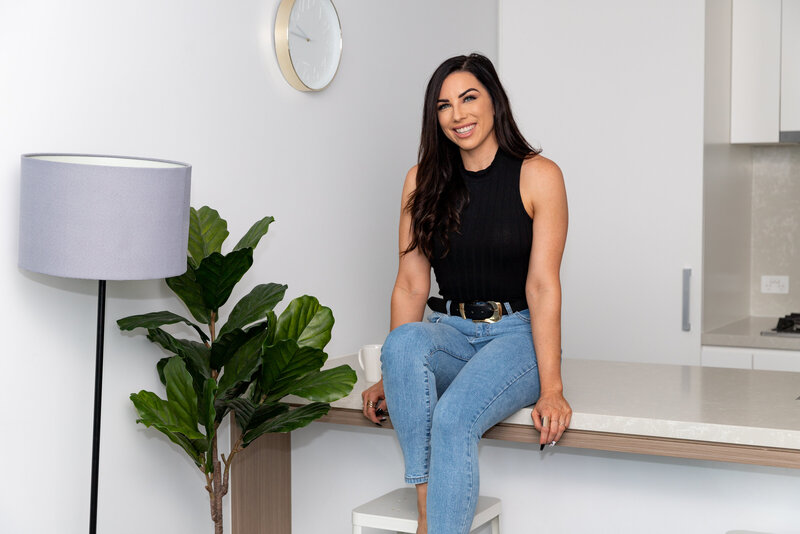 Woman in jeans sitting on the counter