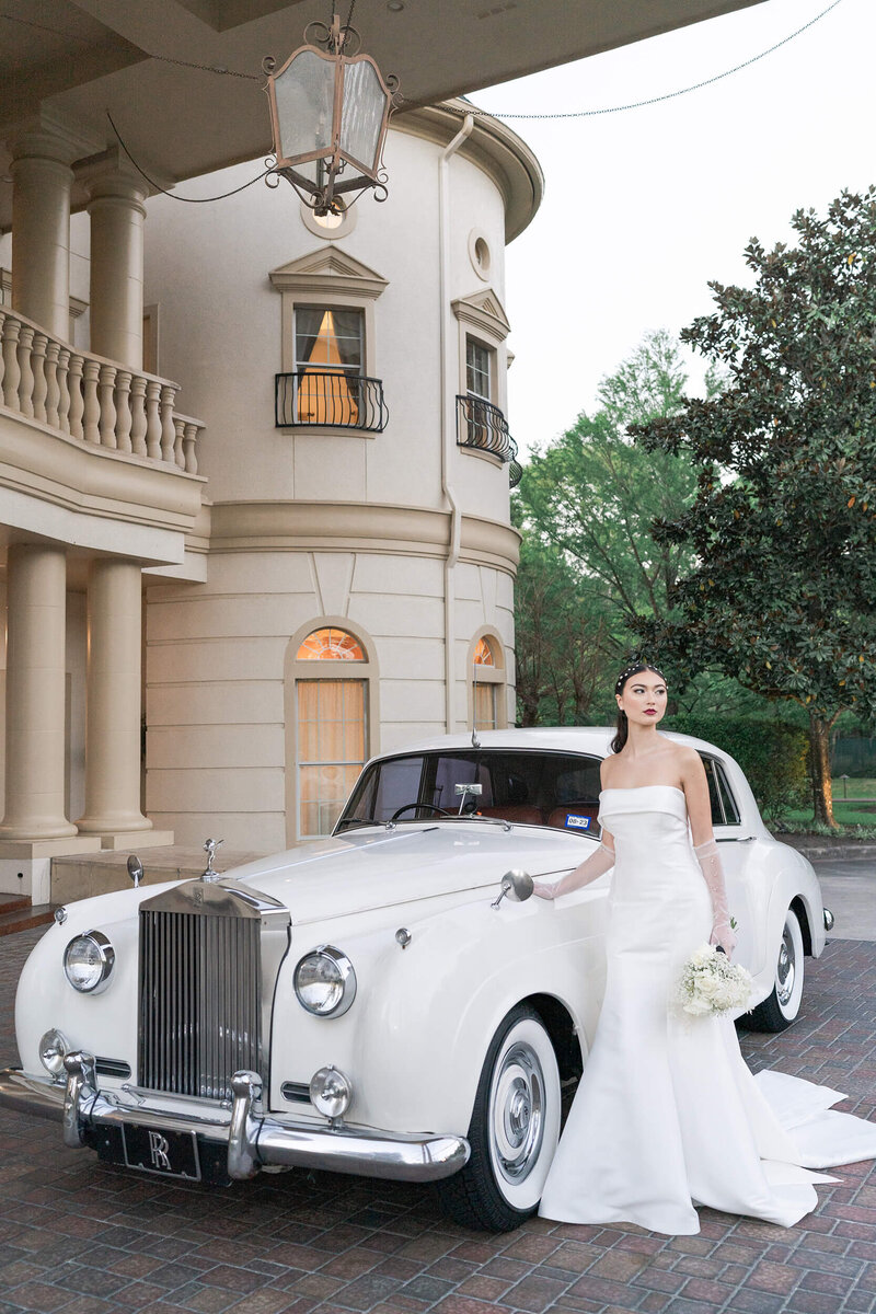 Houstons best wedding photographers Swish and Click Photography Houston bride poses with an old car at Springs Cypress