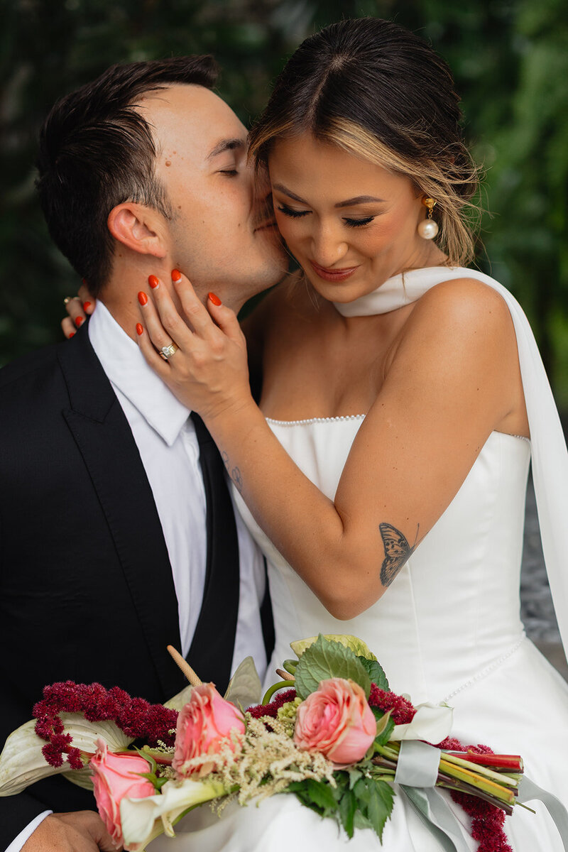 Bride and groom embrace and smile after their wedding in Pensacola, Florida