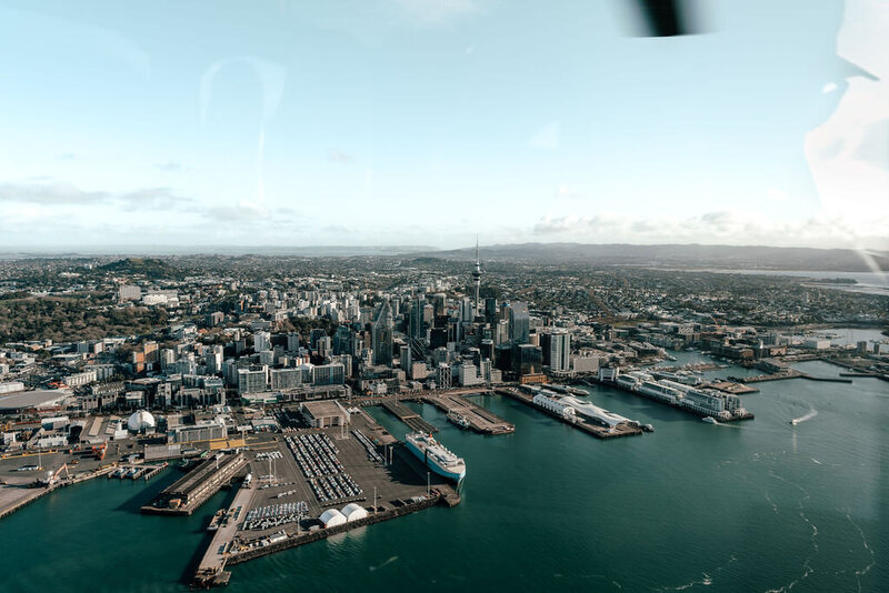 Aerial photograph of Auckland Harbour with sweeping views of the water and city skyline, captured by Zanthe Vorsatz Photography.