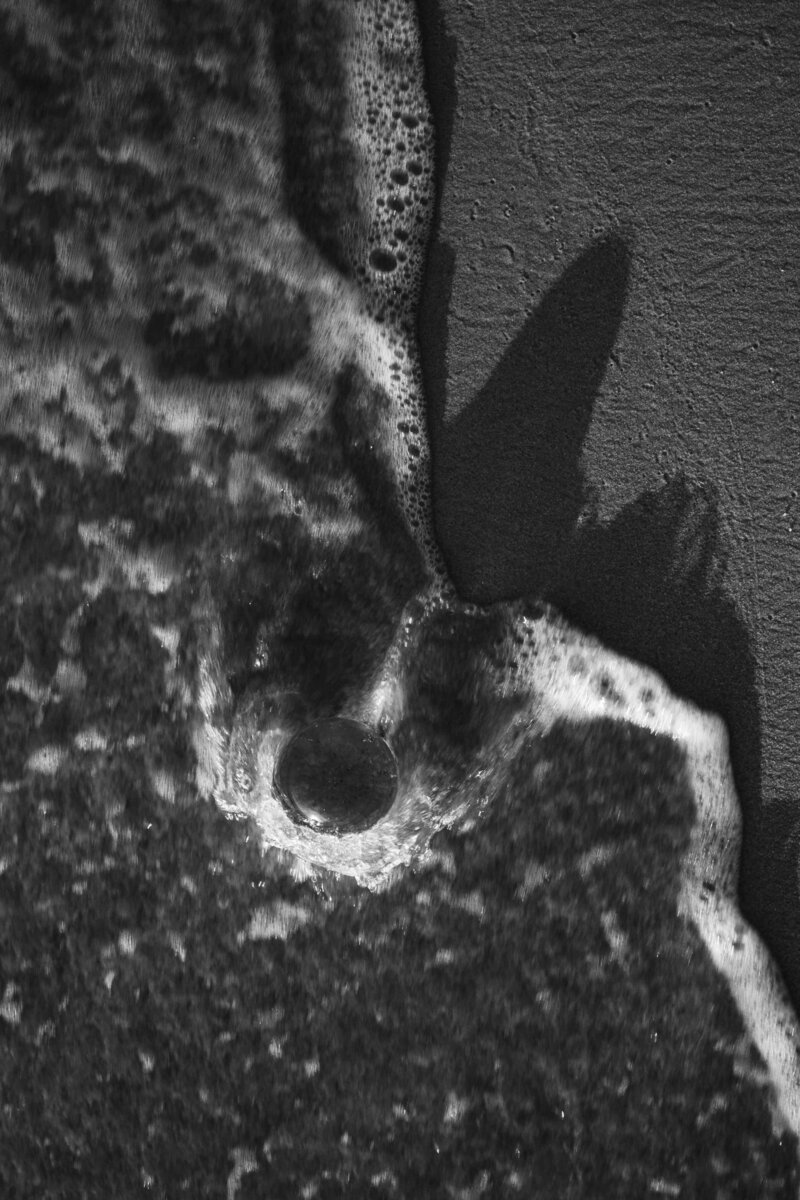 Natalie Bernacchi holding a clear crystal point during a Reiki session, promoting energy healing and chakra balancing.