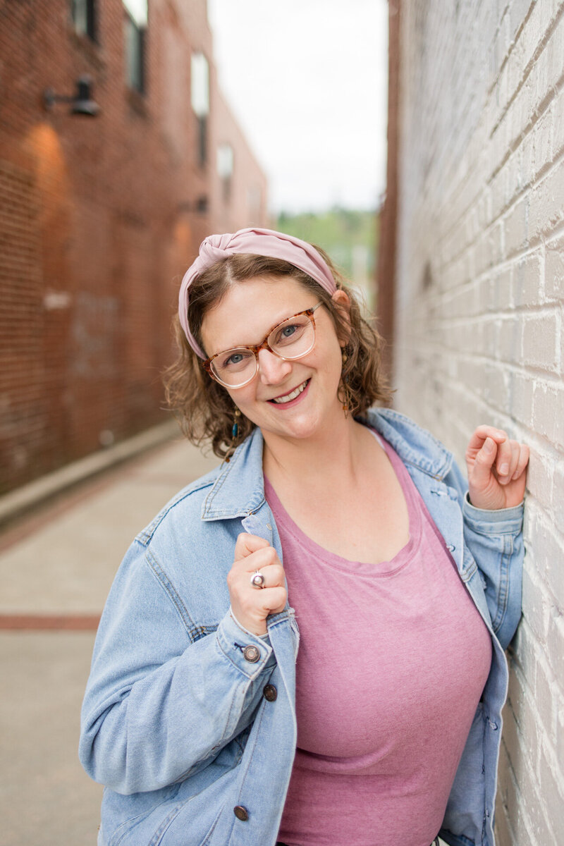 Boone, NC based family, wedding and boudoir photographer Ashley Kubota smiles at the camera.