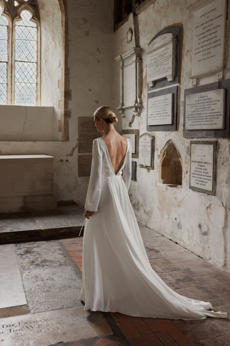 Long sleeve silk wedding dress with deep v back  on natural bride in church