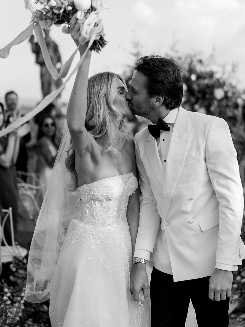 Bride in Monique Lhuillier walks with her father down the aisle at her wedding in Ravello at Villa la Rondinaia