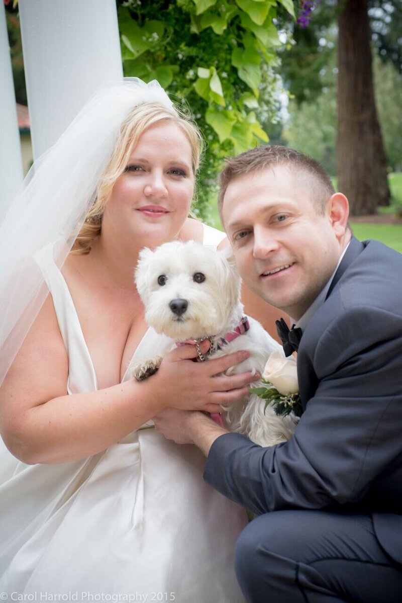 Bride and groom with dog at church wedding