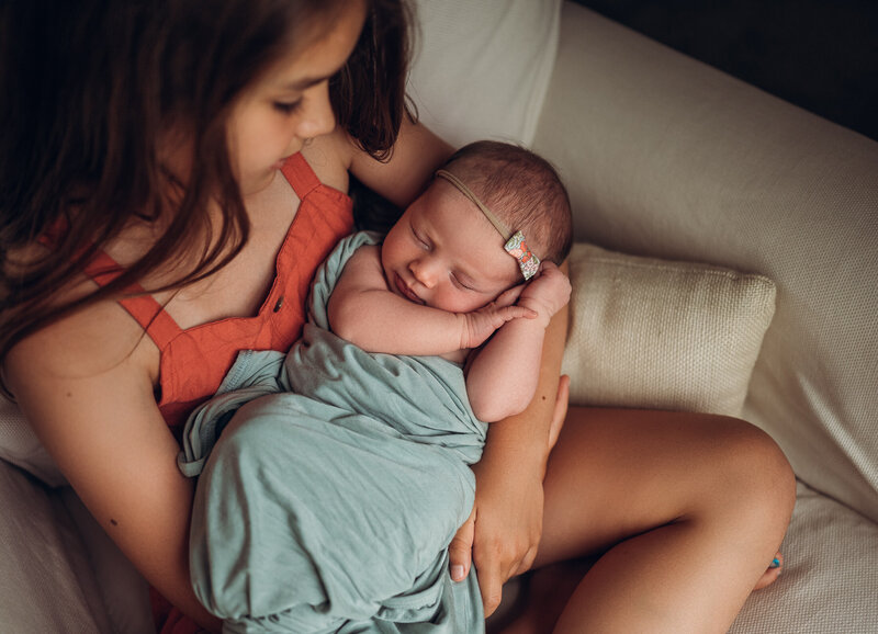 Older sister holding newborn