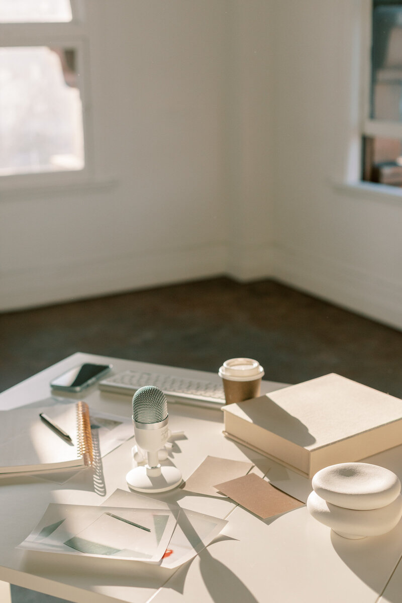 Bunch of books, notepads and coffee  on the desk