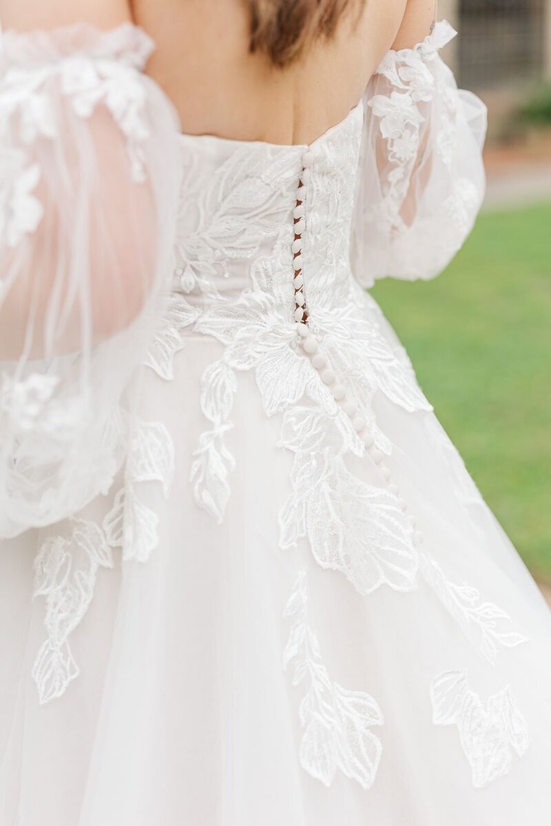 Fine details photographed on the back of a wedding gown