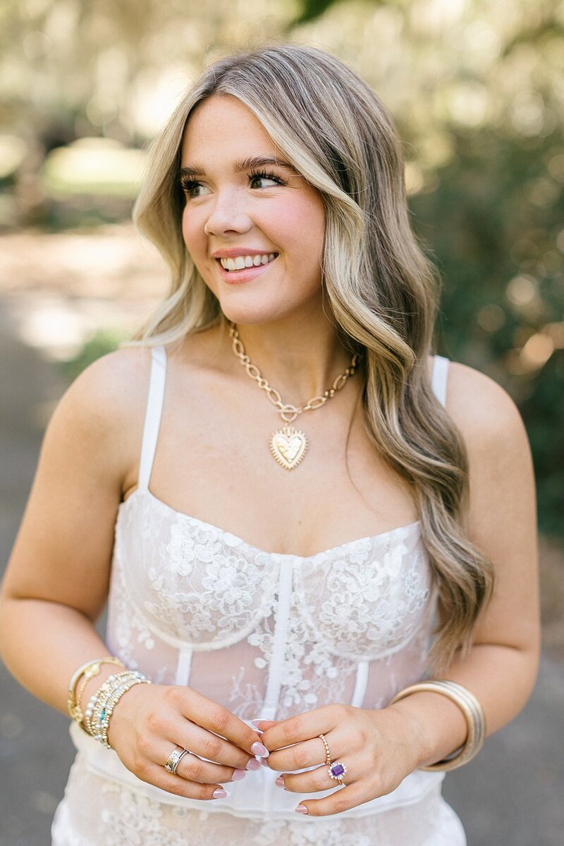 Blue eyed girl looks into the camera and touches her hair