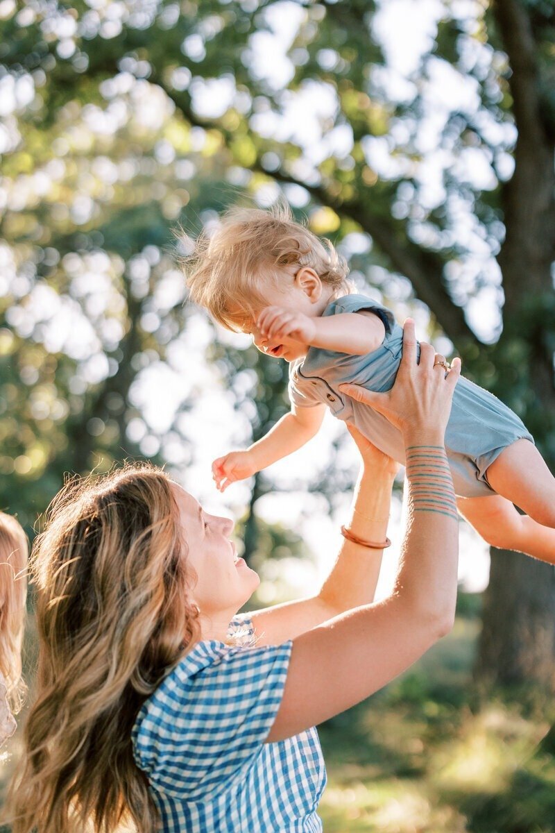 A loving portrait of a mom holding her daughter, captured by Emily Barbara, a family photographer in Milwaukee.