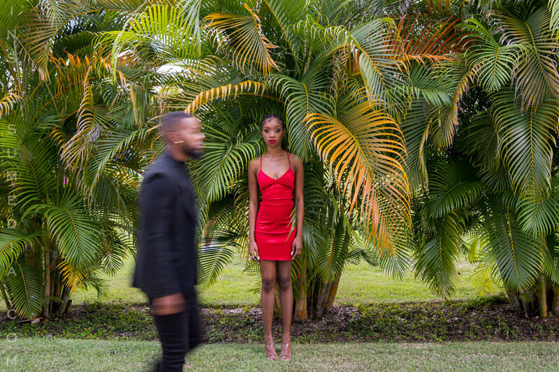 Man walking towards his posing bride-to-be