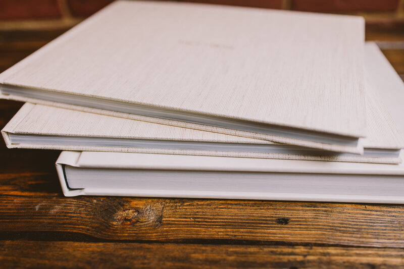 Luxurious white flushmount wedding album along with two smaller parent photo books