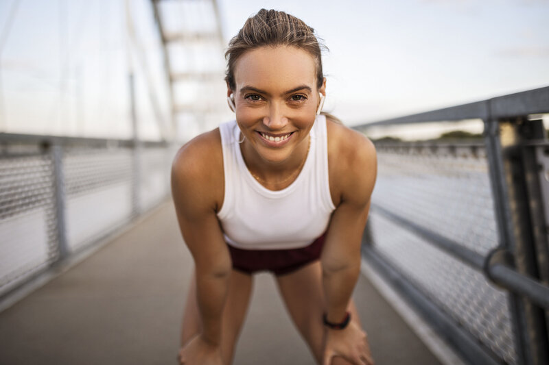 Happy girl smiling on bridge
