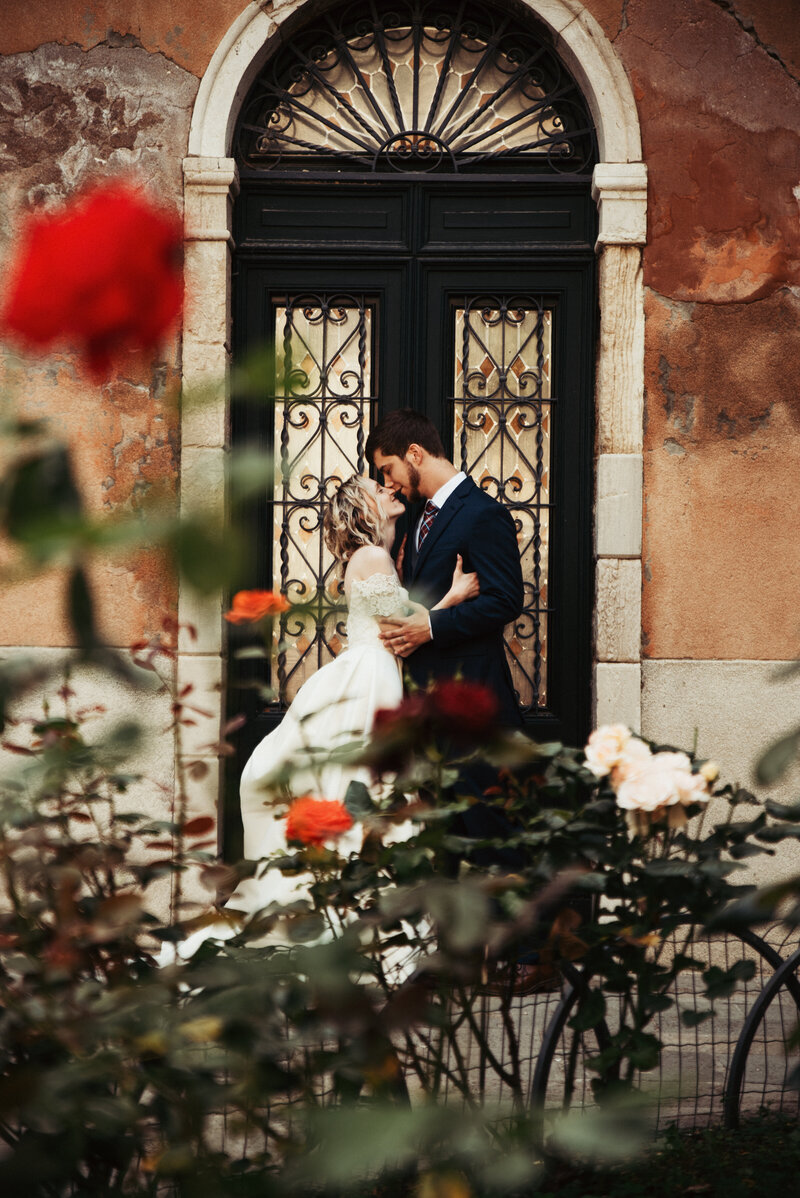 A just married couple share an intimate moment in Venice, Italy. Their