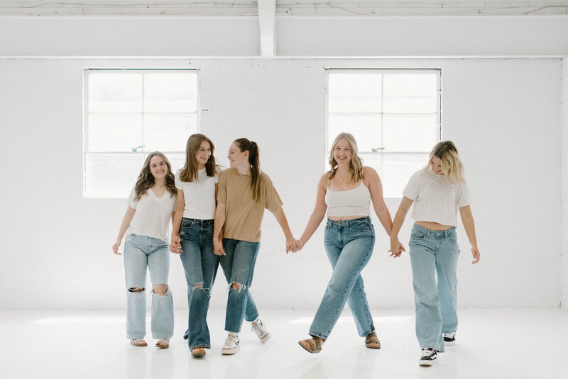 Logan Jade walking with her senior rep team in a photo studio
