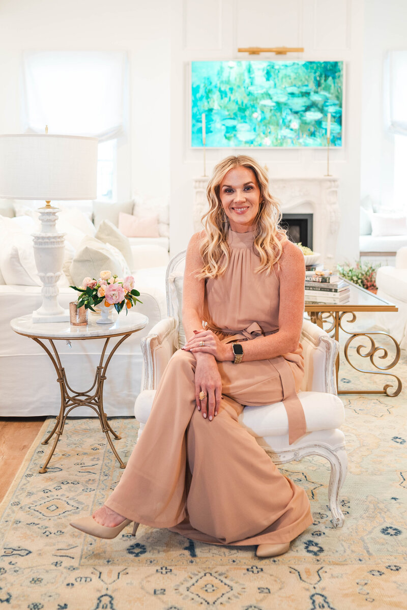 luxury living room design with woman seated  wearing beige jumpsuite