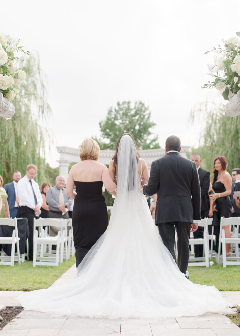 bride-walking-down-aisle-with-parents-524