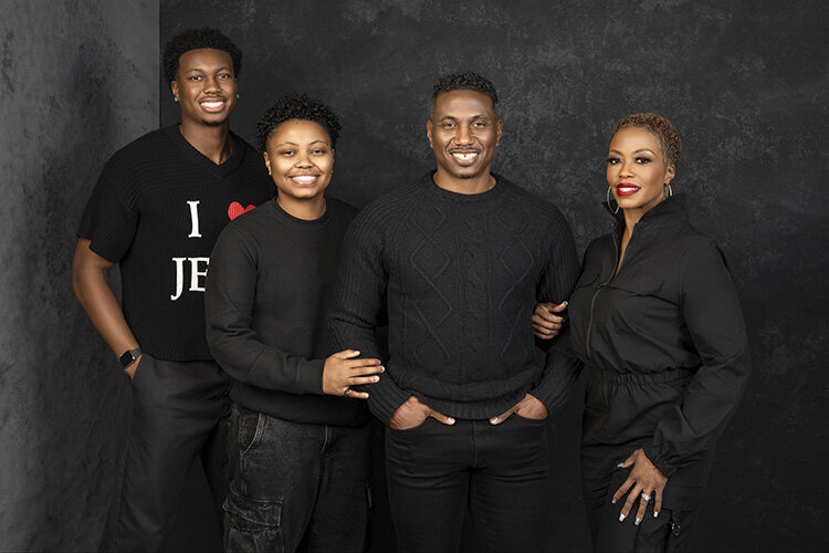 The photographer's family poses for a studio session