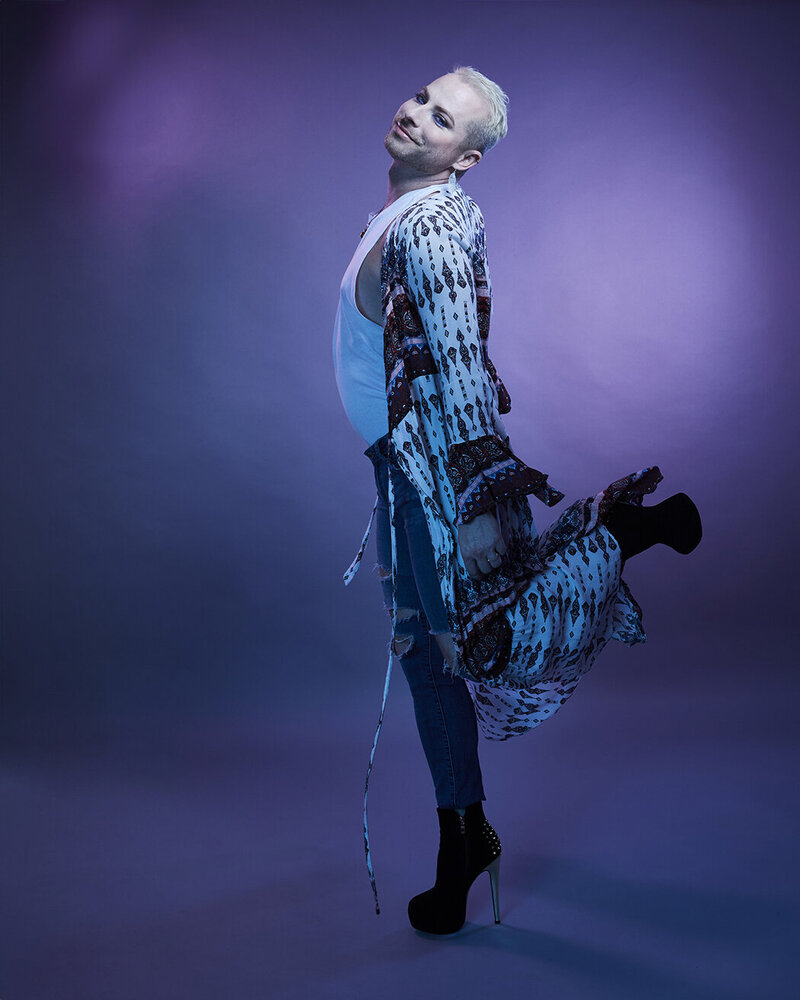 Striking full-body shot of Dain August in a sequined blue ensemble, featuring a dramatic and stylish pose, photographed by Ylva Erevall.