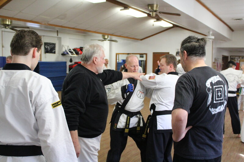 group of people learning martial arts