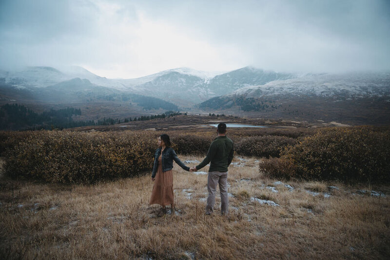 A couple takes their engagement photos in front of Mount Bierstadt in Colorado..