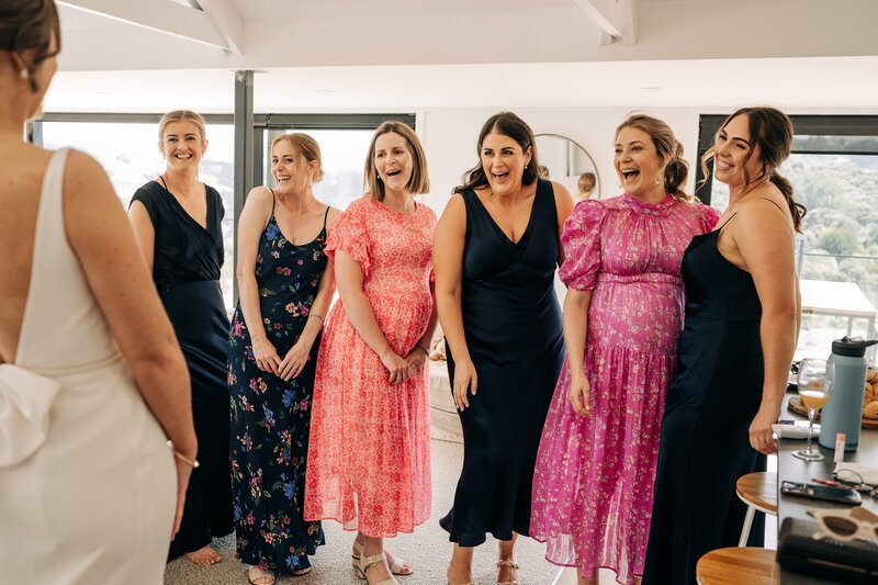 brides friends react to seeing her dressed at their airbnb in akaroa on wedding morning