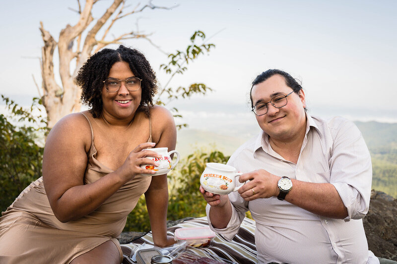 A bride and groom on their elopement day "clink" their rings together during a ceremony in front of the Moss Arts Center at Virginia Tech in Blacksburg, Virginia.
