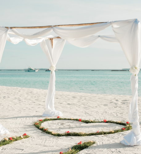 cabana on beach with heart in the sand planned by honeymoon travel planner GG Mack Luxe Travel