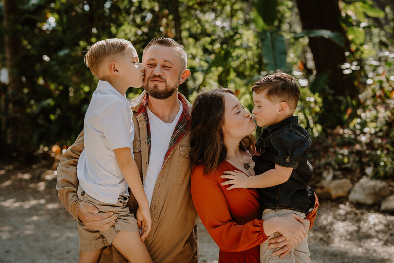 Brandi of The Intuitive Momma with her husband, Bobby and two sons, Liam and Clay