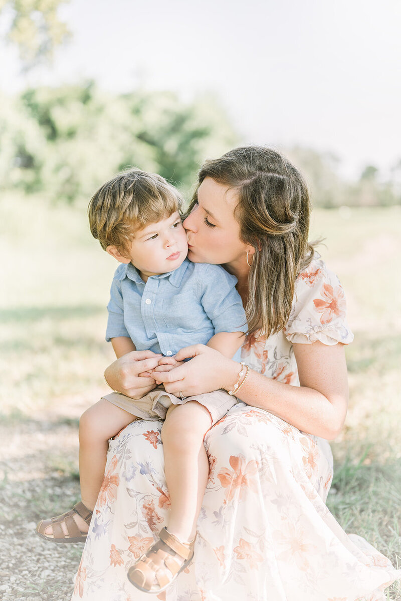 Mother and sun embrace during a morning family photo session.