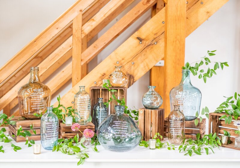 Bottle Seating Chart is a unique seating chart idea with wine crates to create depth and greenery