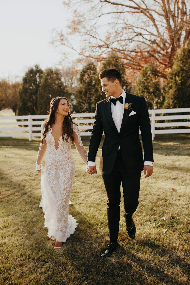 Bride and groom walking down the aisle  under clear tent