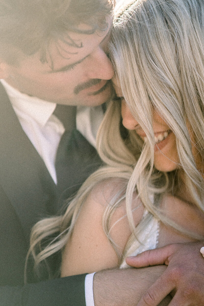 Bride and groom embrace at Dolphin Bay Resort wedding in Pismo Beach, CA