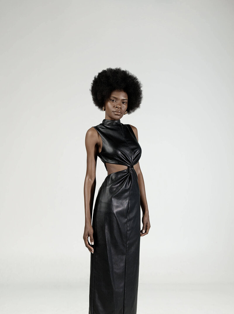 woman in a black dress for a lookbook standing in a studio