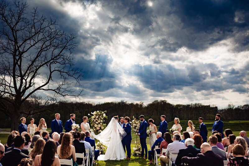 Wedding ceremony with a dramatic cloudy sky at Sylvania Country Club 