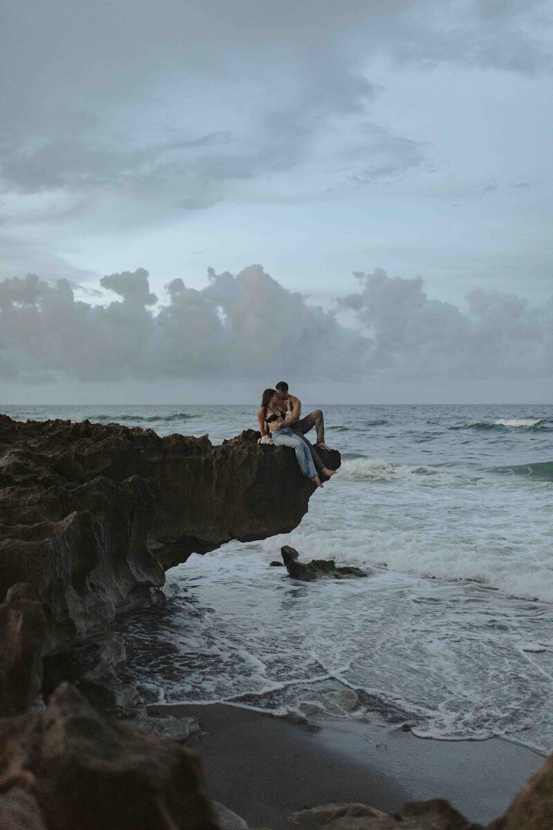 Couple embracing on a cliff edge