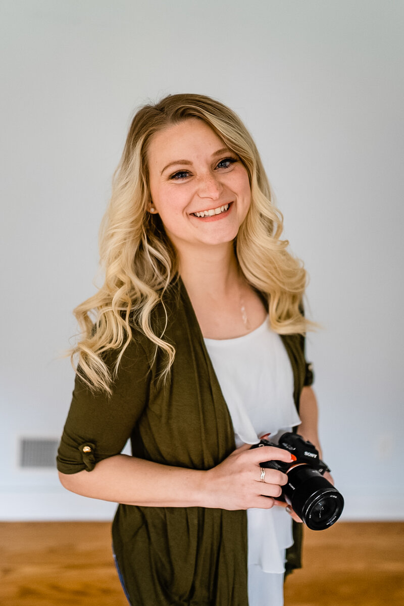 Staci, Virginia elopement photographer, smiling and holding camera ready to plan your
adventure