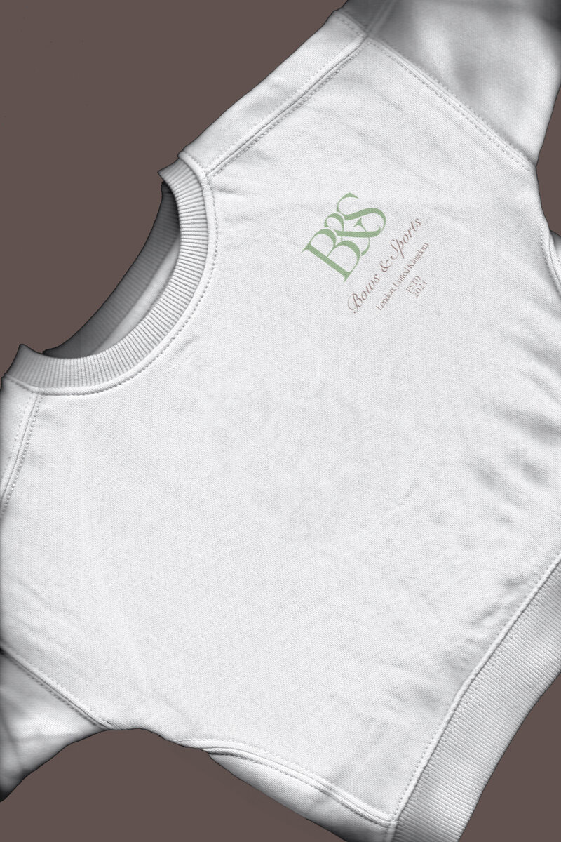 Bows & Sports logo design on sweatshirt, showcasing brand identity for lifestyle apparel.