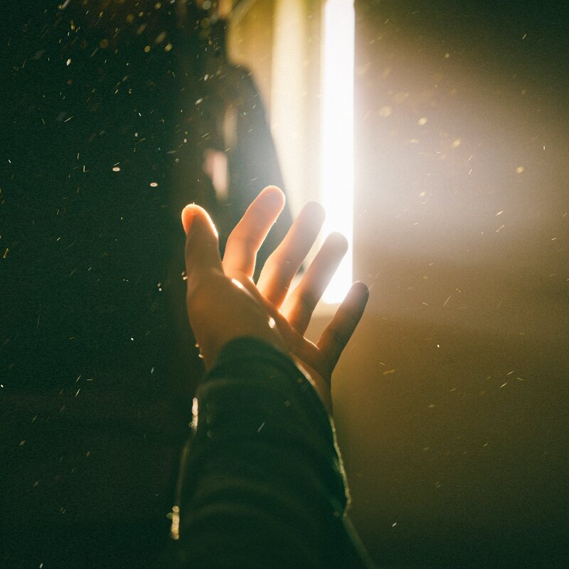 hand reaching out for light