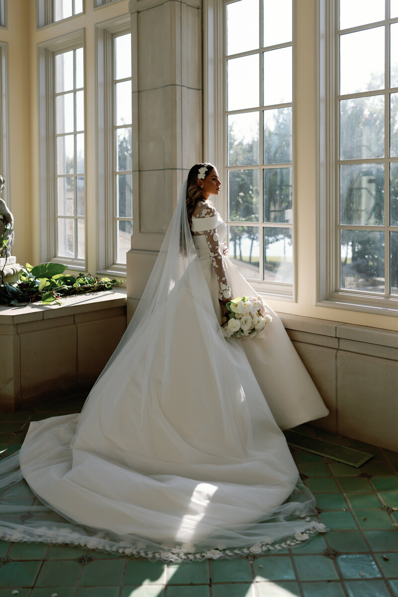 Bride twirling in a wedding gown at The Olana in Hickory Creek, Texas. A grand and luxurious wedding venue.