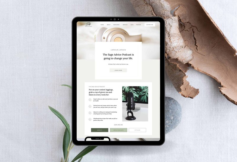 An ipad showing a podcast page from a Showit website template over wood and sage leaves